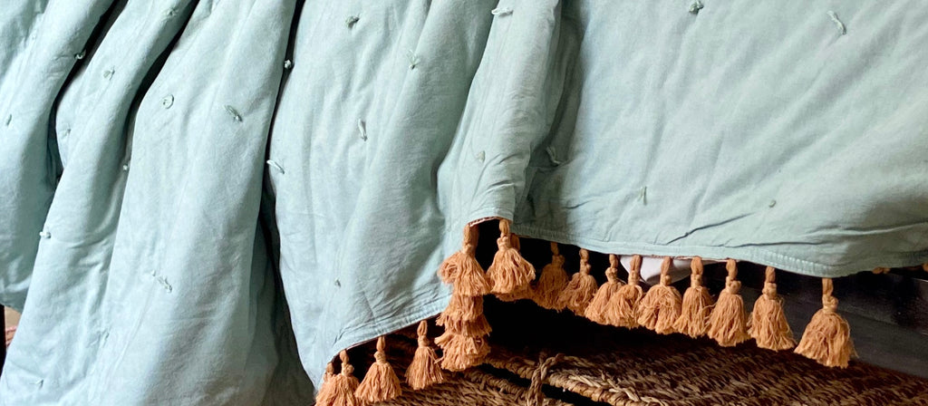 Organic cotton quilted bedspread with fringed tassels. Indian bedspread in sage with terracotta tassels